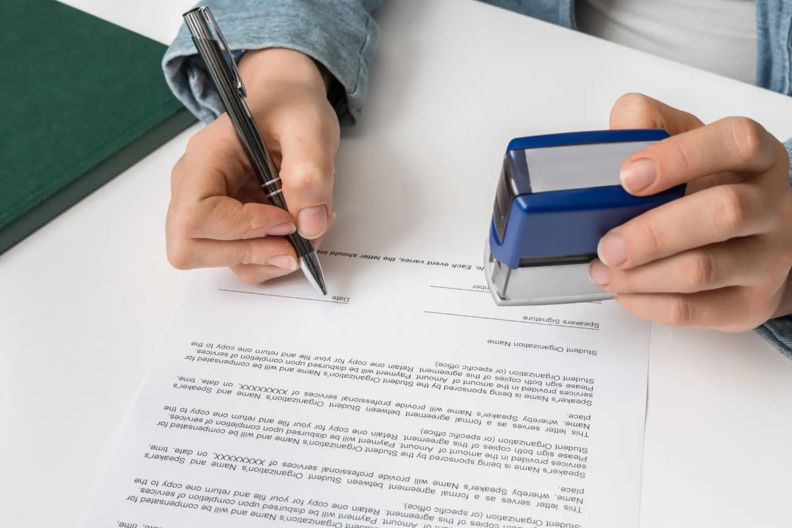 Signer dating a document while holding a notary stamp